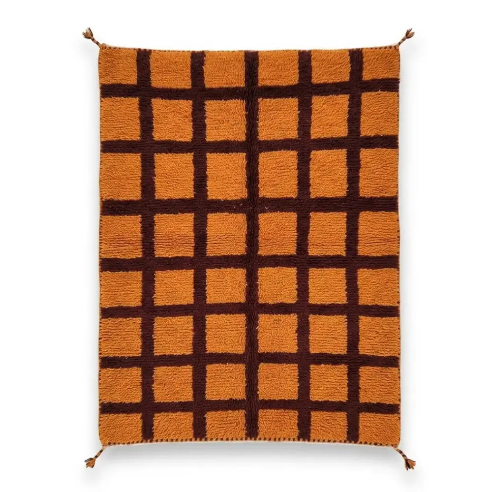 Tapis berbère en laine à carreaux orange et marron chocolat, style Beni M'guild artisanal avec pompons.
