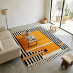 Tapis berbère jaune moutarde avec rayures noires et motifs graphiques dans salon moderne lumineux style bohème