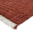 coin de tapis berbère terracotta avec franges écrues et texture épaisse, parfait pour décoration bohème chic